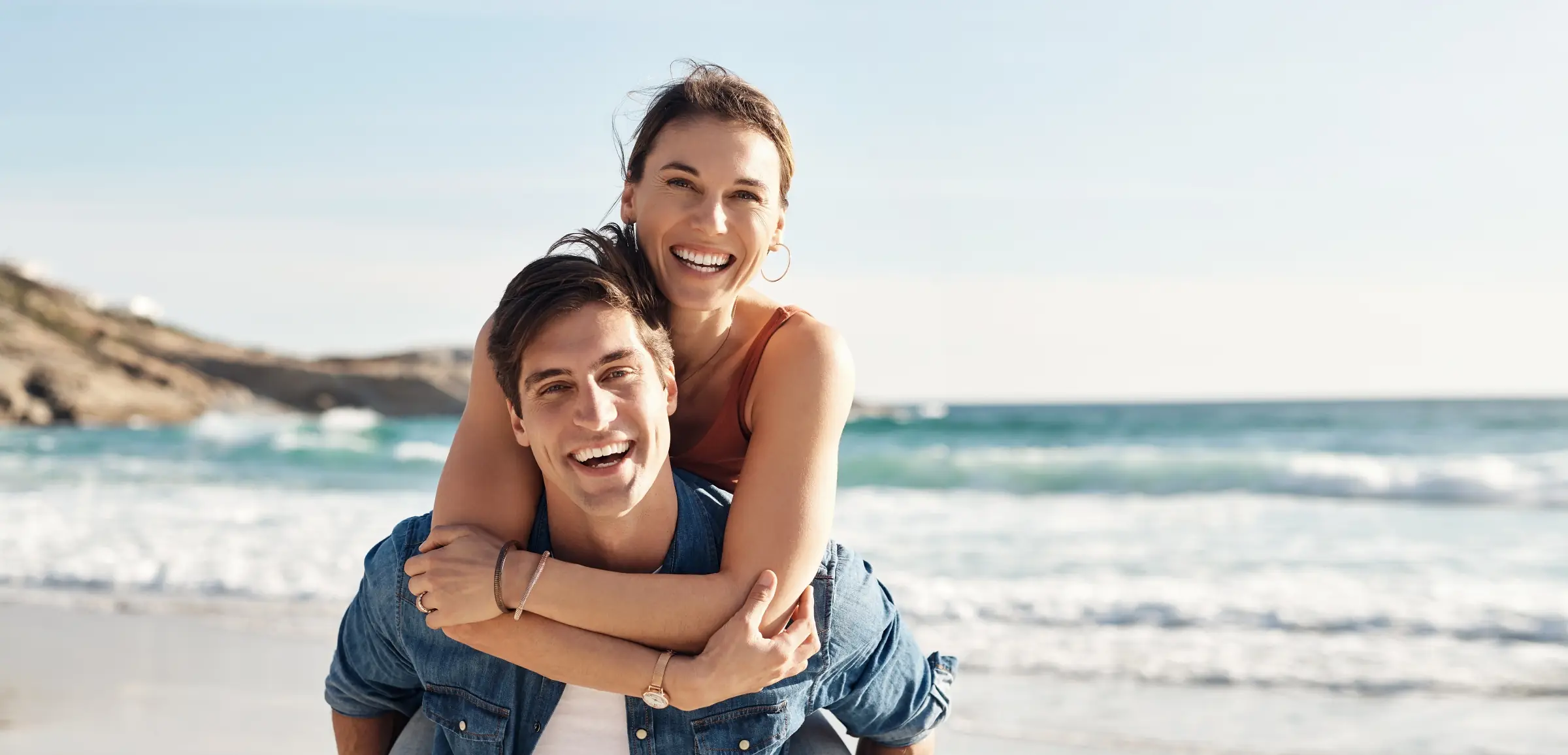 Couple enjoying a sunny beach day.