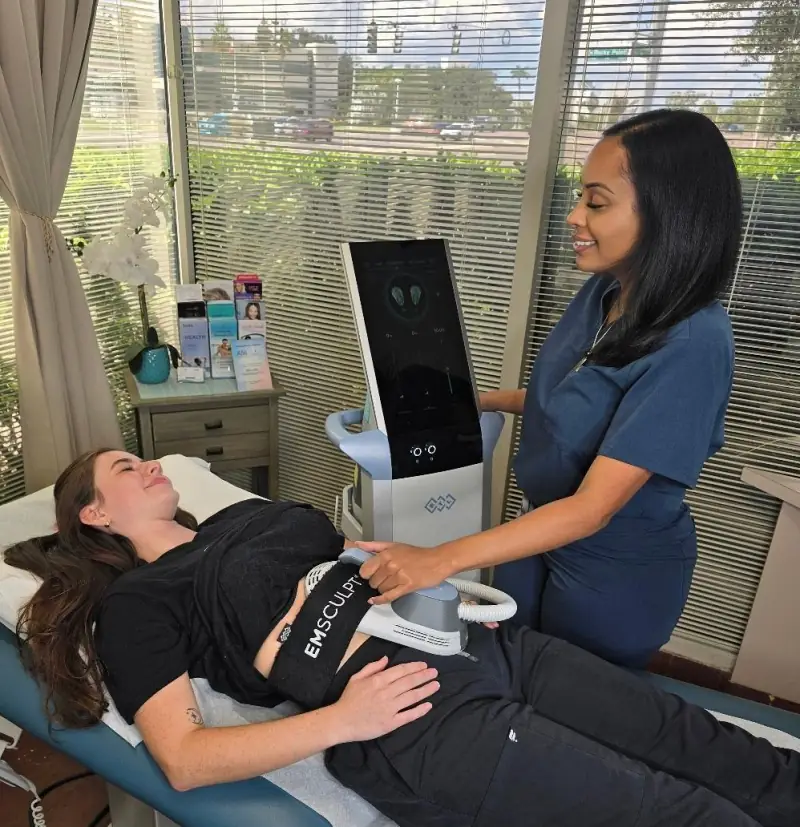 Real patient and practioner at Vein and Cosmetic Center of Tampa Bay during an Emsculpt treatment.