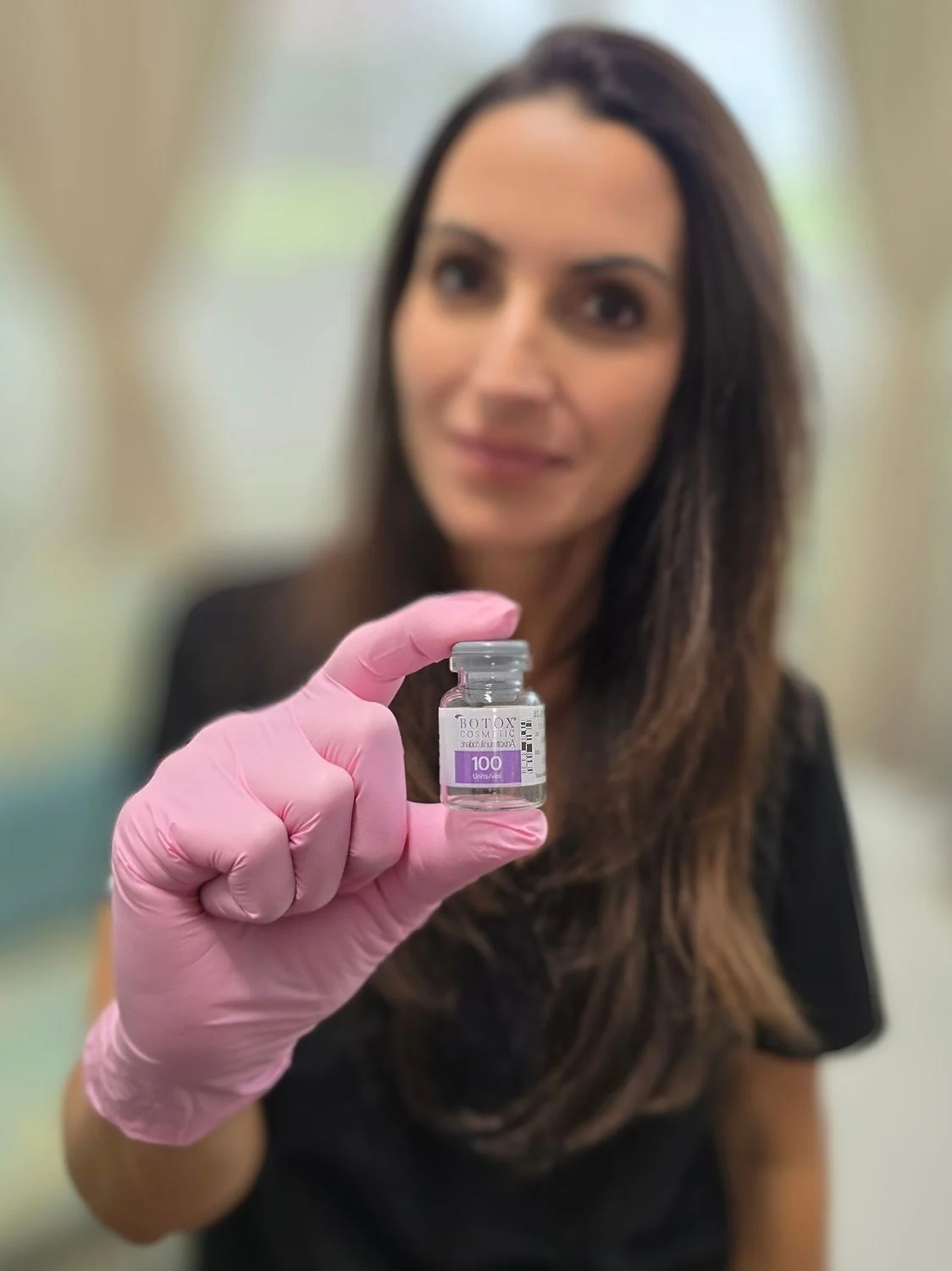 Vein & Cosmetic Center provider holding a vial of botox