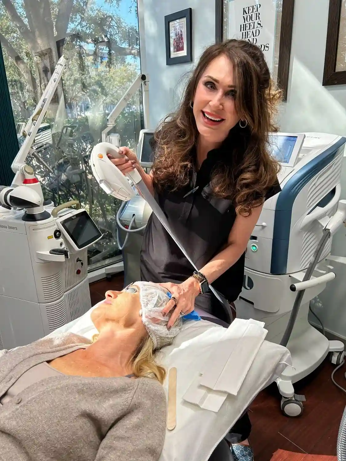 Vein & Cosmetic Center provider smiling while treating patient's skin with IPL photo facial