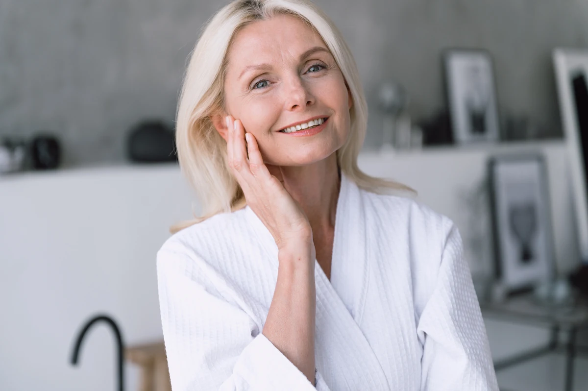 beautiful mature woman touching face