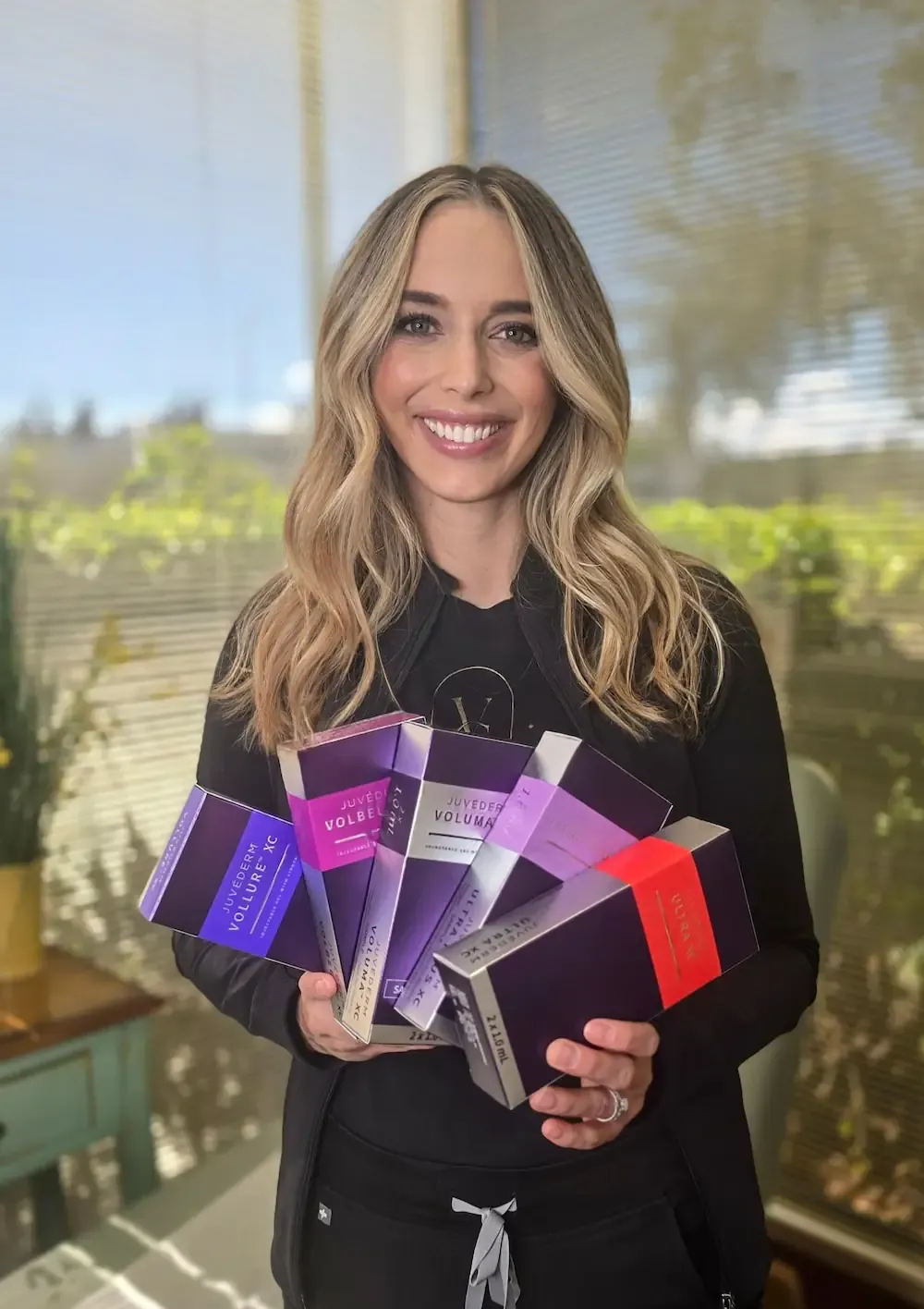 Aesthetic provider Kate at Vein & Cosmetic Center in Tampa Bay holding Juvederm product