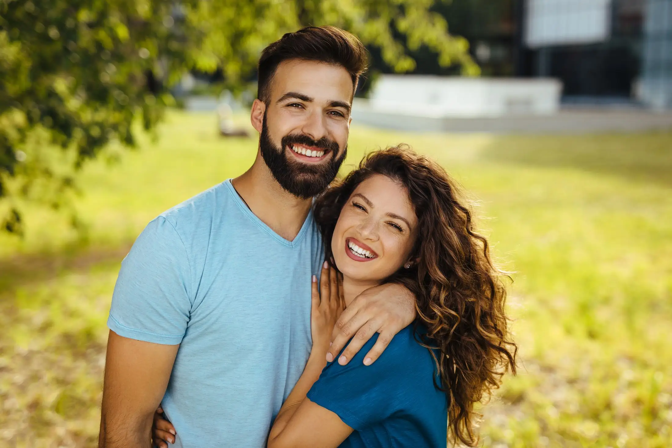 Happy couple smiling outdoors after starting BHRT
