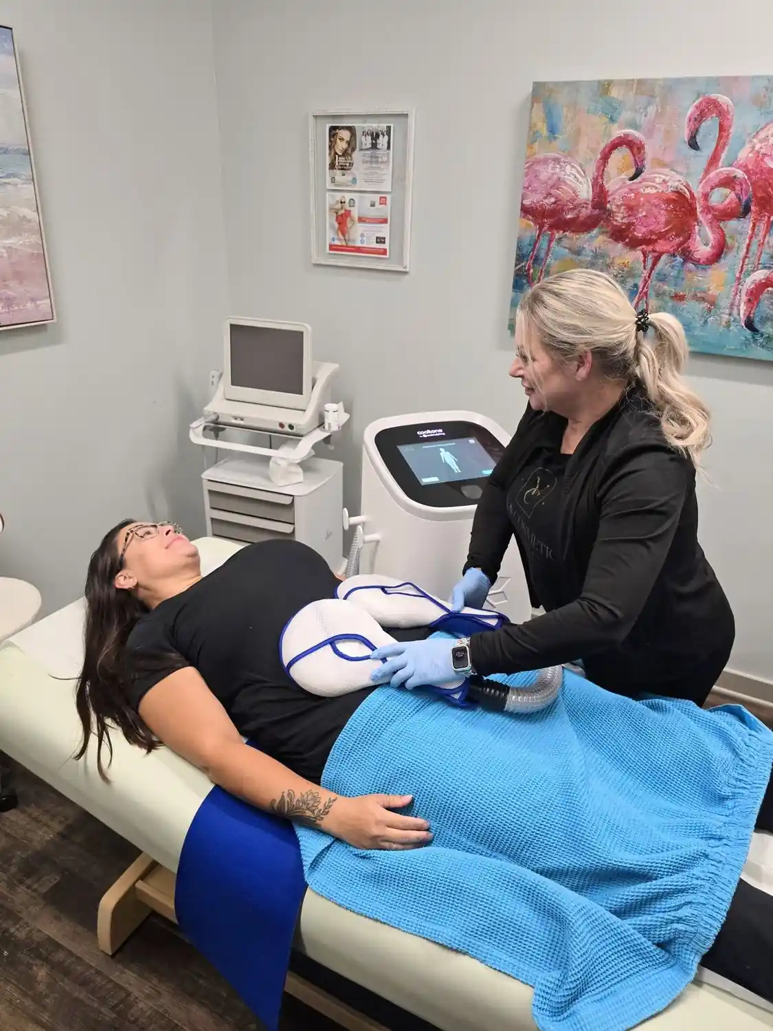 Provider applying CoolTone applicators to a patient's abdomen during treatment