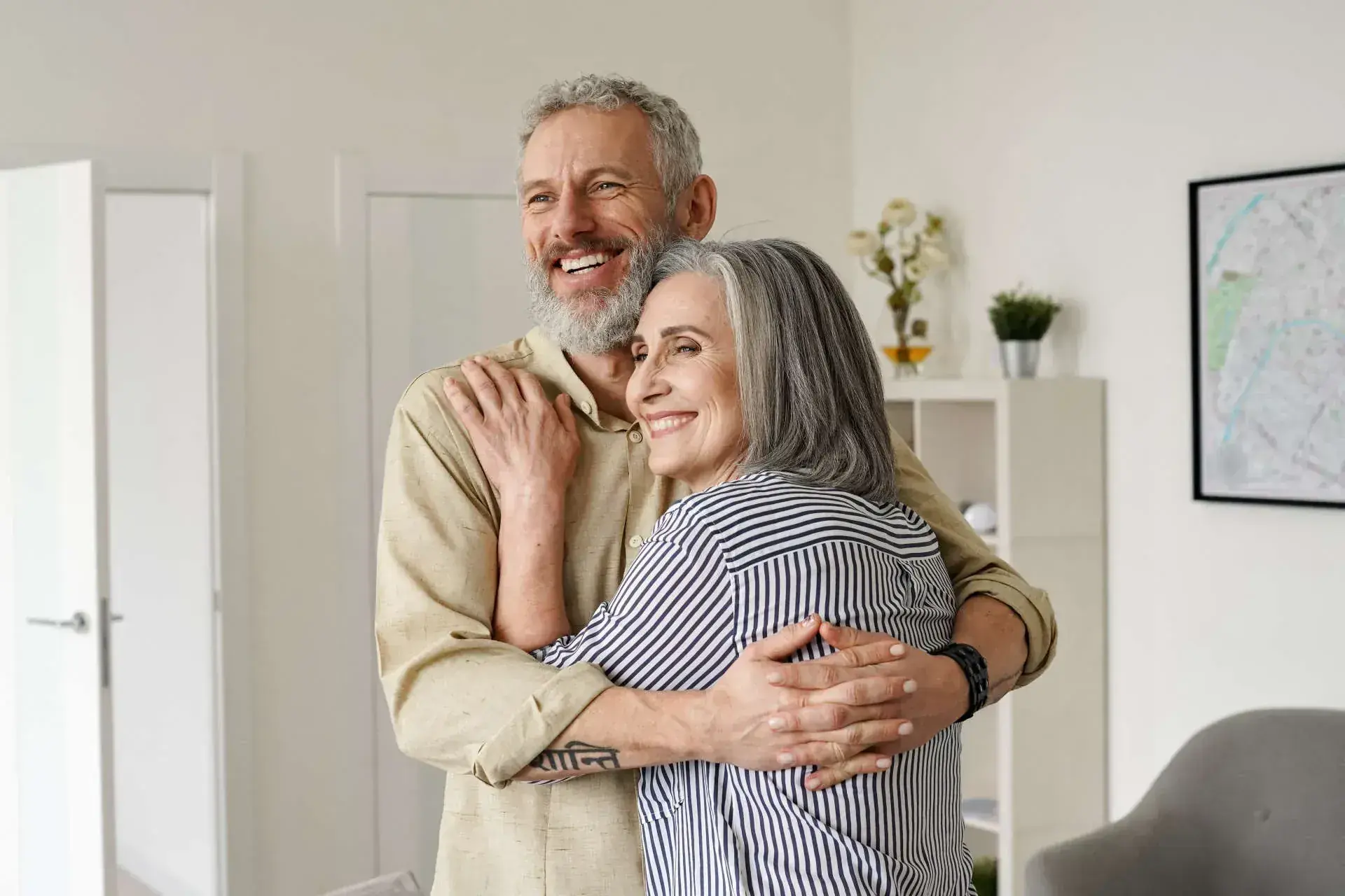happy senior couple embracing indoors