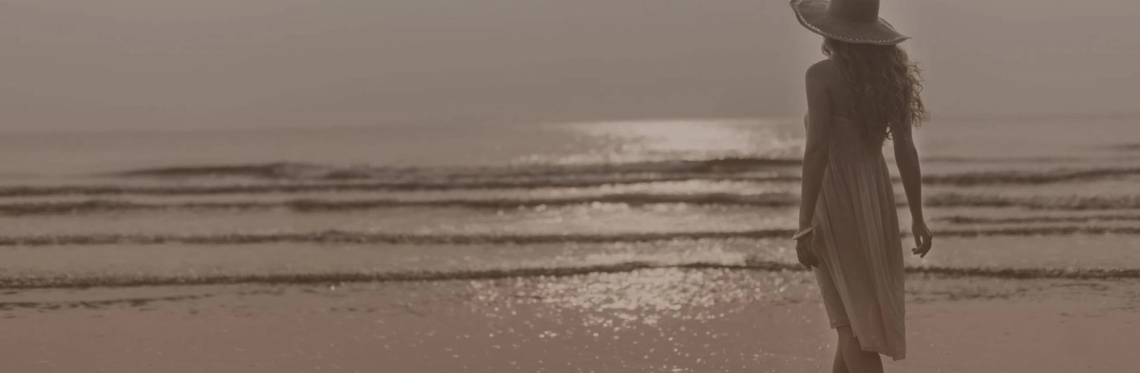 beautiful woman silhouette at the beach during sunset