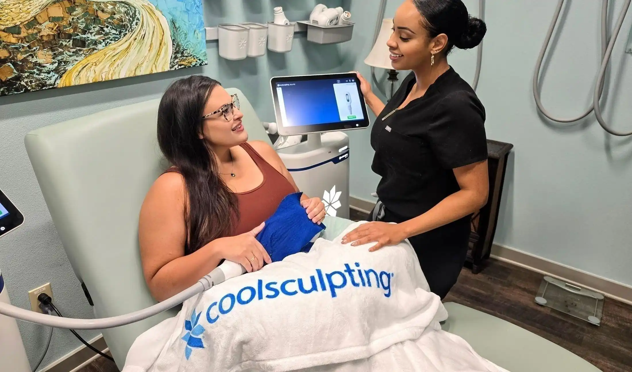 Provider consulting with a patient during a CoolSculpting Elite treatment