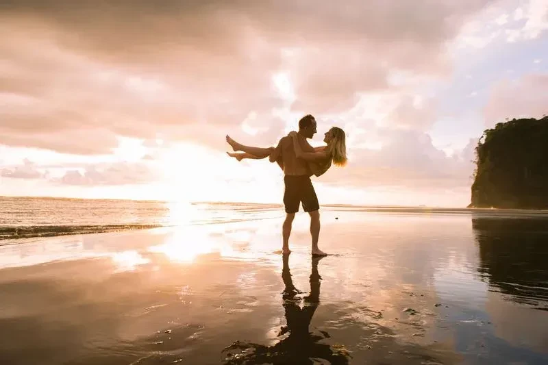 Romantic couple on the beach during sunset