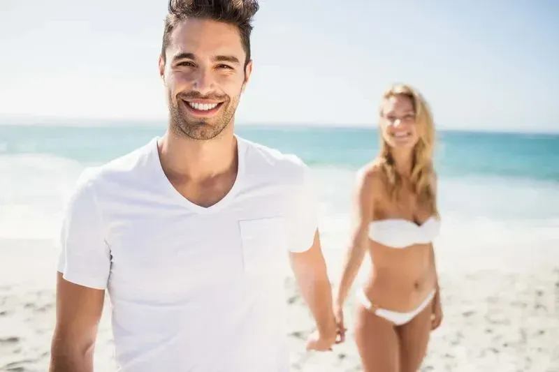 happy couple holding hands on the beach