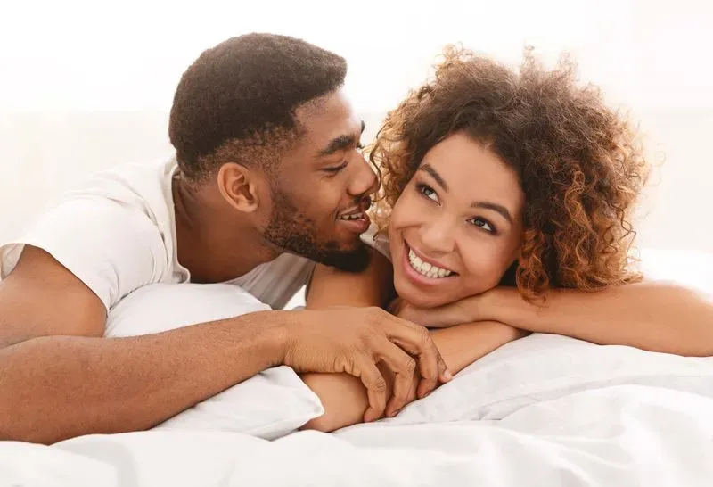 happy couple in bed