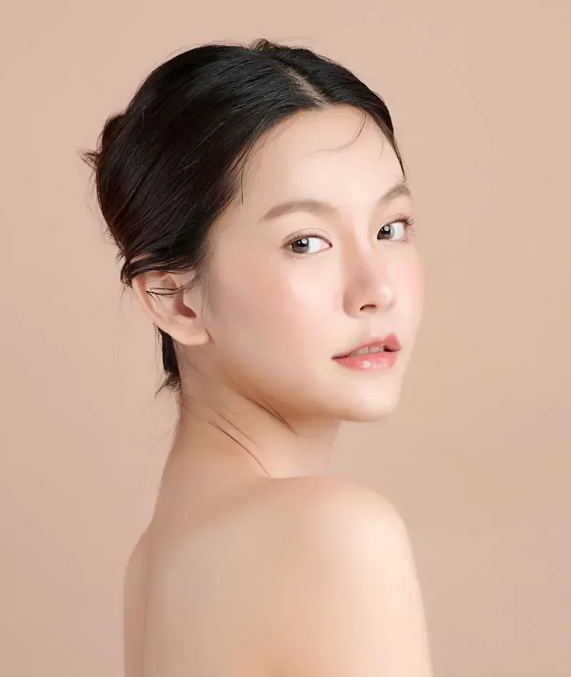 confident woman with healthy glowing skin after hydrafacial treatment