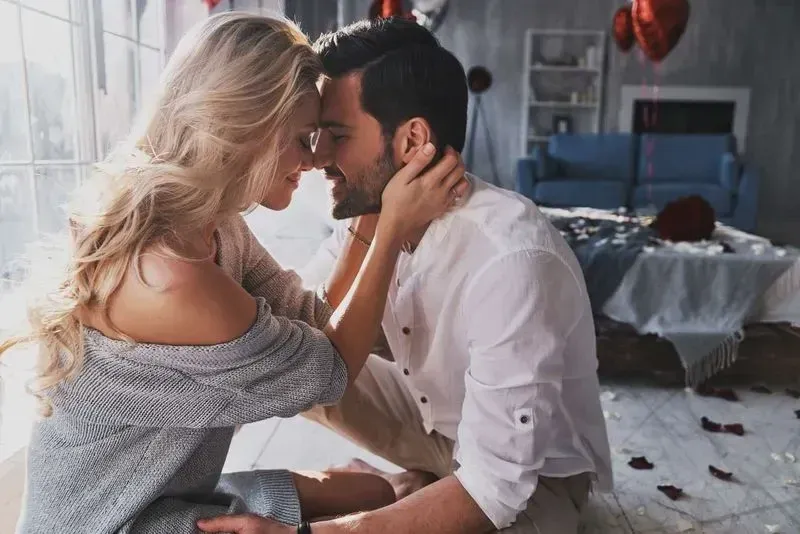 Intimate couple embracing indoors