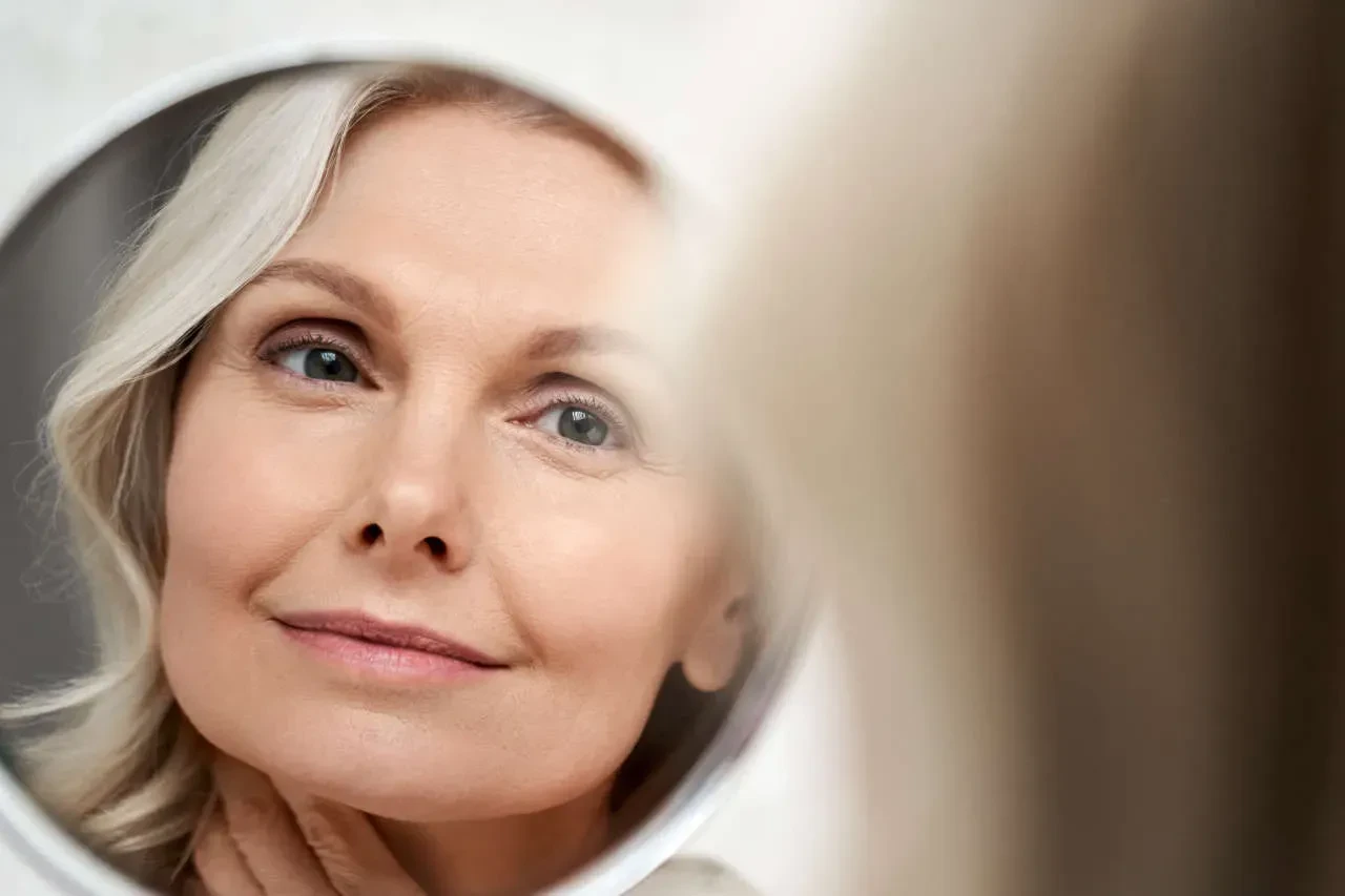 mature woman looking in mirror