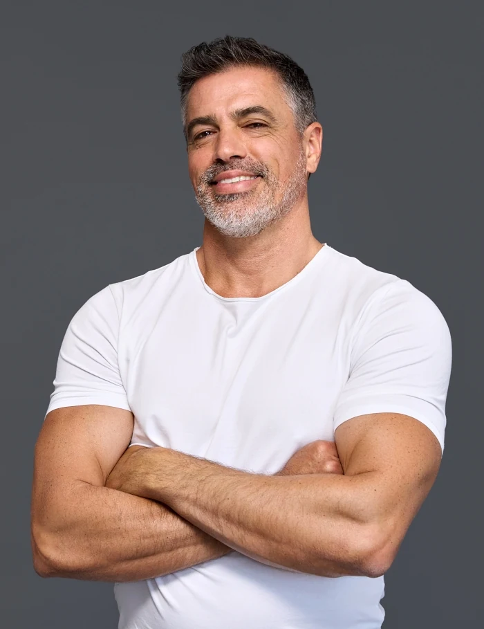 Confident man smiling, feeling the vitality benefits of peptide therapy